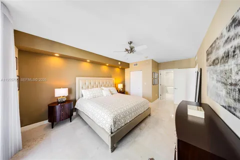 a spacious bedroom with a bed and window