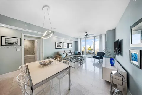 a view of a livingroom with furniture and a flat screen tv