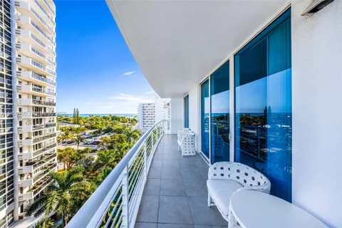 a hallway with a large window and a rug
