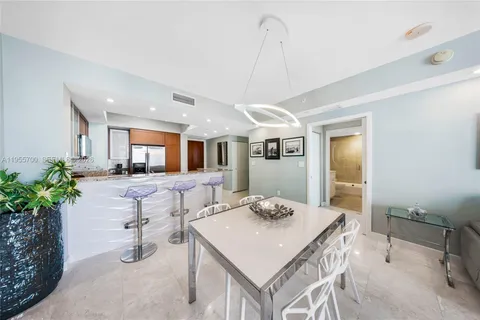 a view of a dining room with furniture and a potted plant