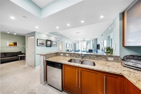 a kitchen with stainless steel appliances granite countertop a sink and a stove