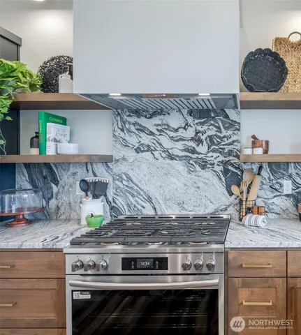 a bathroom with a granite countertop toilet sink and mirror