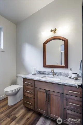 a living room with furniture a floor to ceiling window and a chandelier