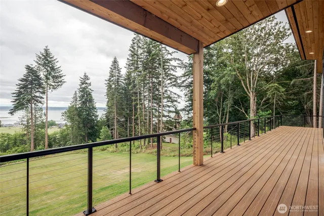 a living room with fireplace furniture and a large window