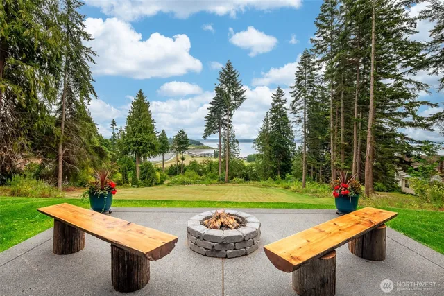 a view of a house with swimming pool and sitting area