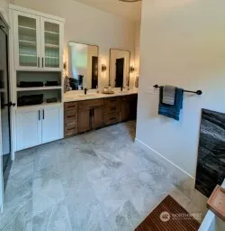 a view of a kitchen with wooden floor and a ceiling fan