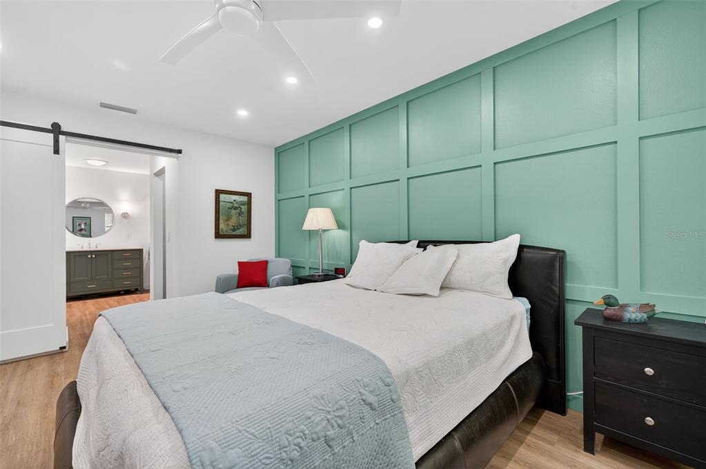 4916 Troon Lane New Port Richey, FL 34655 - Photo 12 of 53 a spacious bedroom with a bed and a dresser