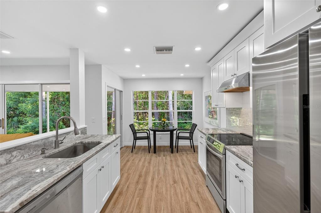 4916 Troon Lane New Port Richey, FL 34655 - Photo 28 of 53 a large kitchen with a large window and stainless steel appliances