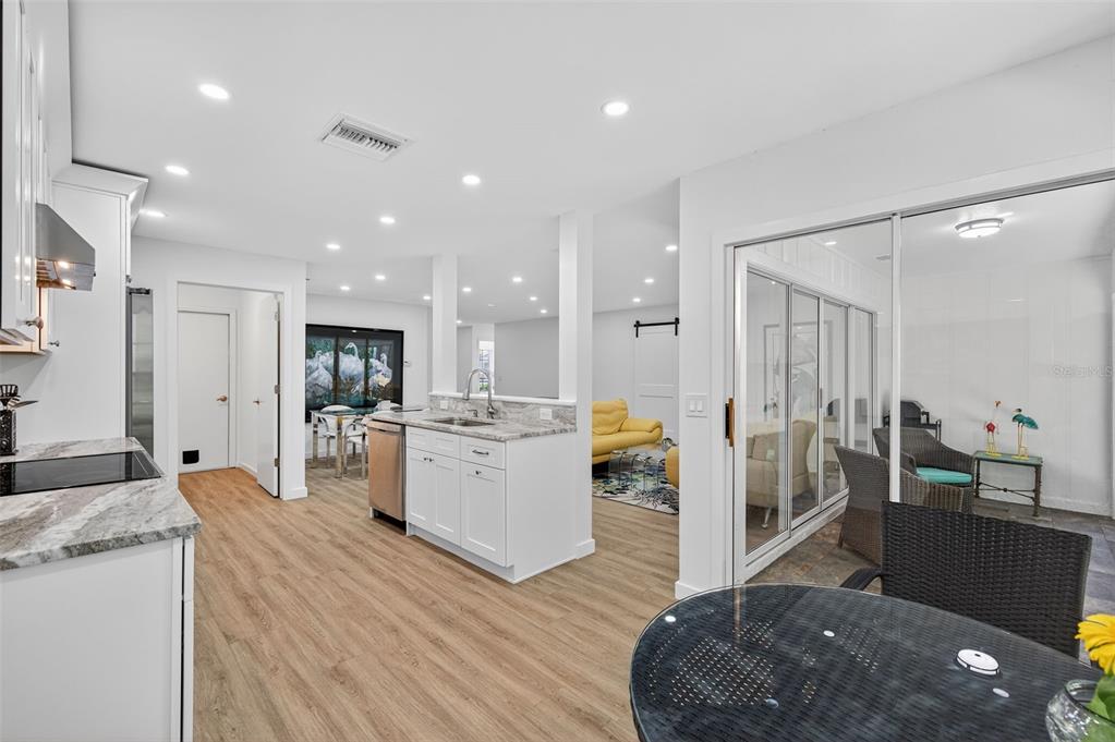 4916 Troon Lane New Port Richey, FL 34655 - Photo 31 of 53 a open kitchen with white cabinets and stainless steel appliances