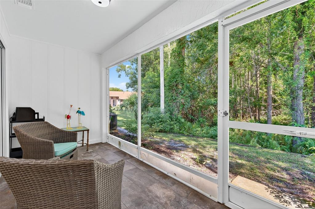 4916 Troon Lane New Port Richey, FL 34655 - Photo 33 of 53 a living room with couch and a floor to ceiling window