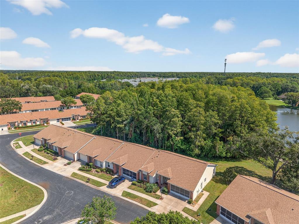 4916 Troon Lane New Port Richey, FL 34655 - Photo 42 of 53 an aerial view of a house with a garden and lake view