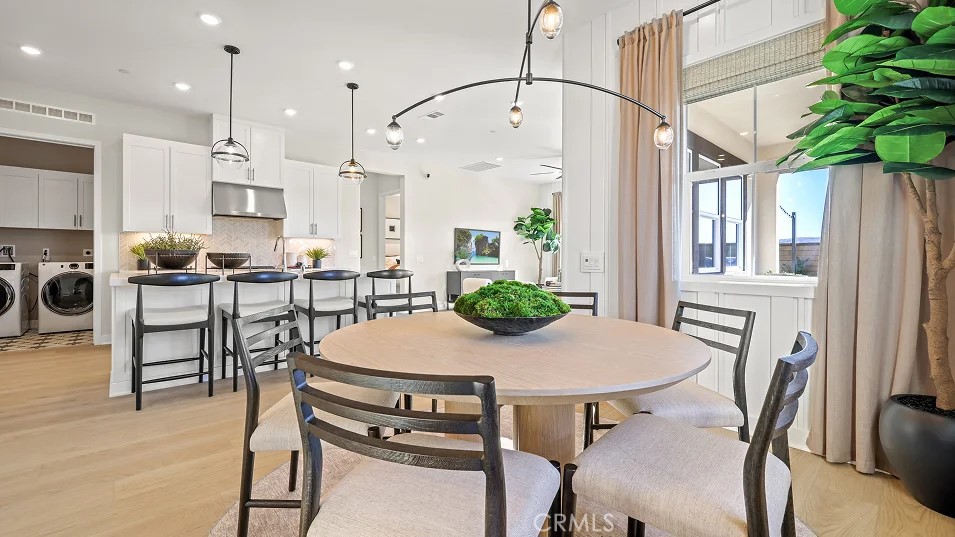 a view of a dining room with furniture and a potted plant