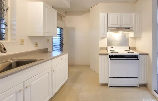 a kitchen with cabinets and window