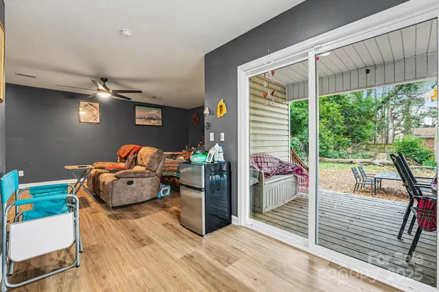 a bedroom with furniture and a large window