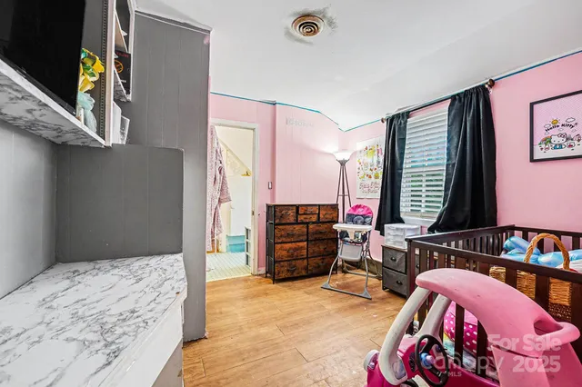 a bedroom with furniture and a window