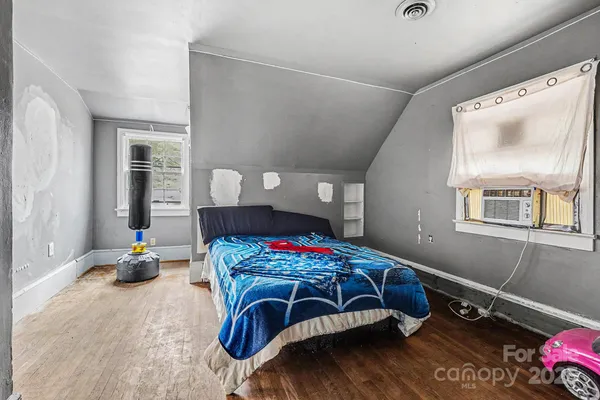 a bedroom with a bed closet and a window