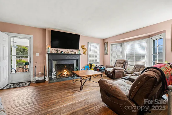 a living room with furniture fireplace and flat screen tv