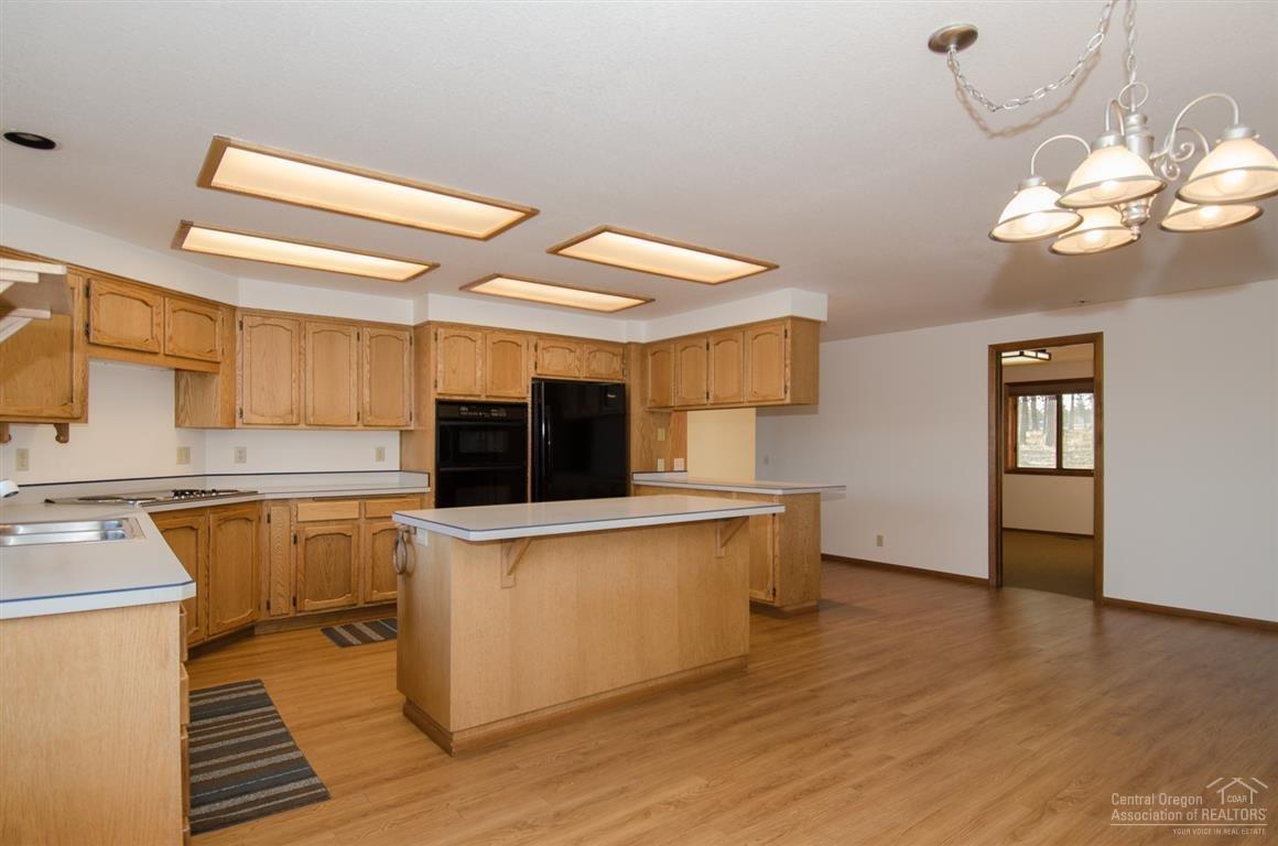 20903 Knott Road Bend, OR 97702 - Photo 11 of 23 a kitchen with stainless steel appliances a stove top oven a sink a counter space and cabinets