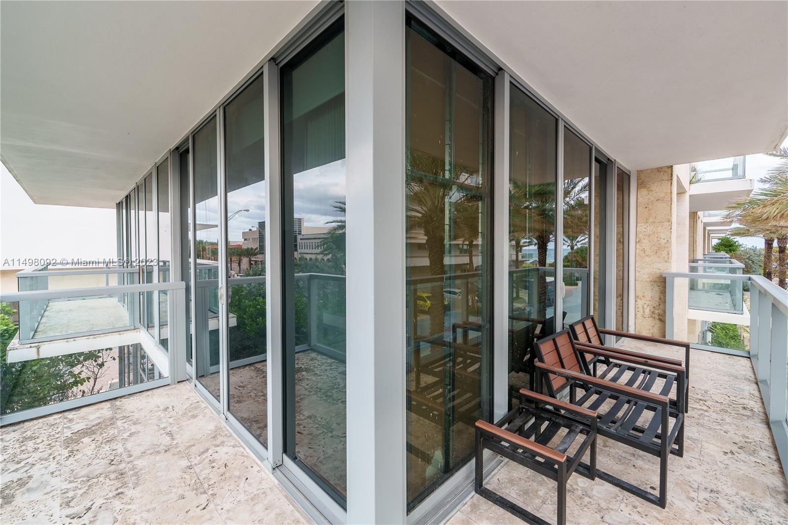 9501 Collins Avenue, Unit 1 Surfside, FL 33154 - Photo 28 of 35 a view of a balcony with a couch and wooden floor