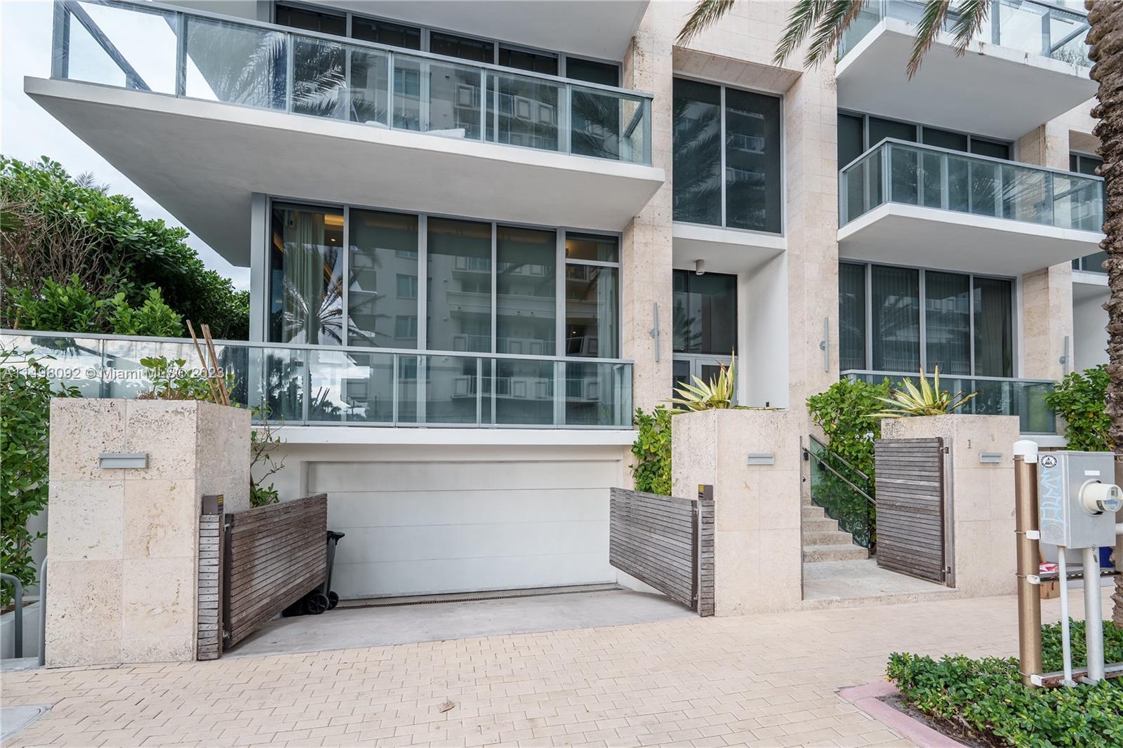 9501 Collins Avenue, Unit 1 Surfside, FL 33154 - Photo 34 of 35 a view of white house with a potted plant and a large window