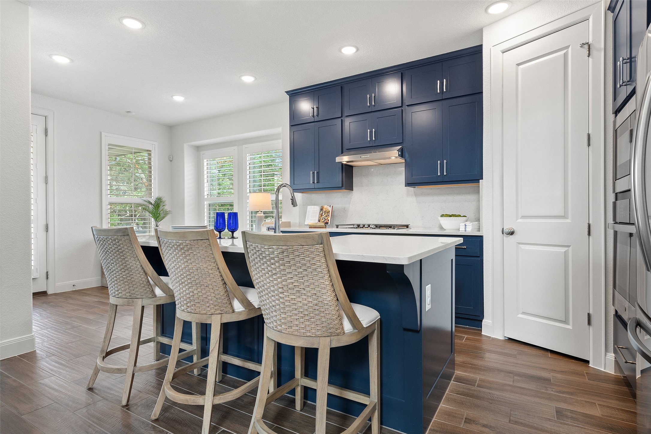 604 Pecan Bottom Trail Georgetown, TX 78628 - Photo 12 of 40 a kitchen with a dining table chairs and refrigerator