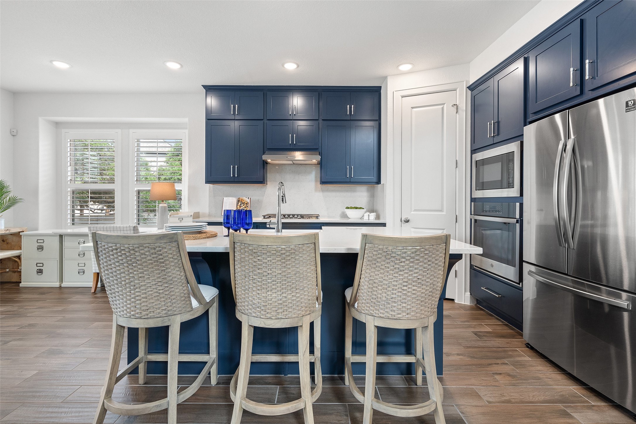 604 Pecan Bottom Trail Georgetown, TX 78628 - Photo 13 of 40 a kitchen with stainless steel appliances granite countertop a dining table chairs refrigerator and sink