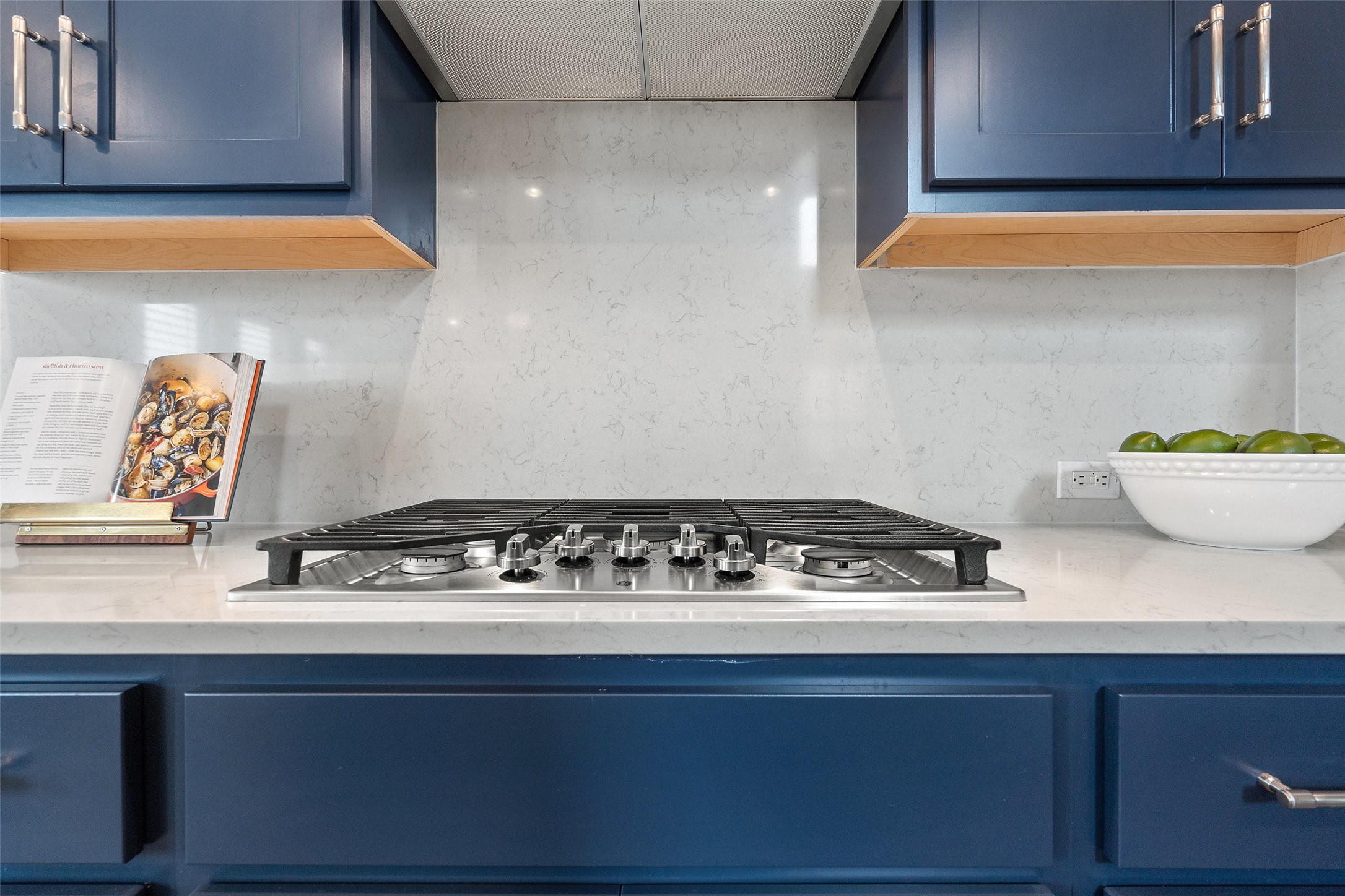 604 Pecan Bottom Trail Georgetown, TX 78628 - Photo 14 of 40 Kitchen featuring blue cabinets, tasteful backsplash, and light stone counters