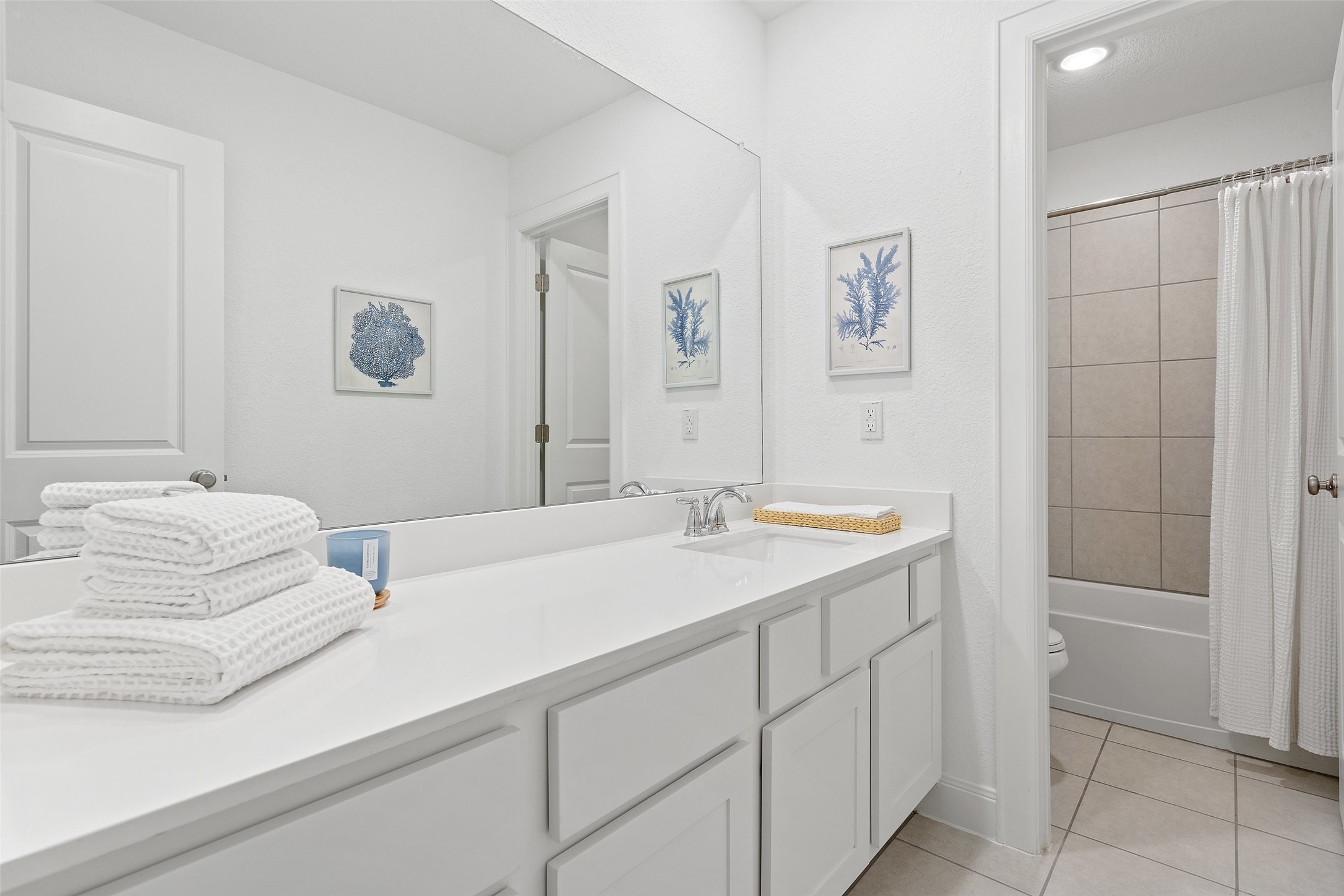 604 Pecan Bottom Trail Georgetown, TX 78628 - Photo 25 of 40 Bathroom featuring vanity, light tile patterned floors, and shower / bath combo