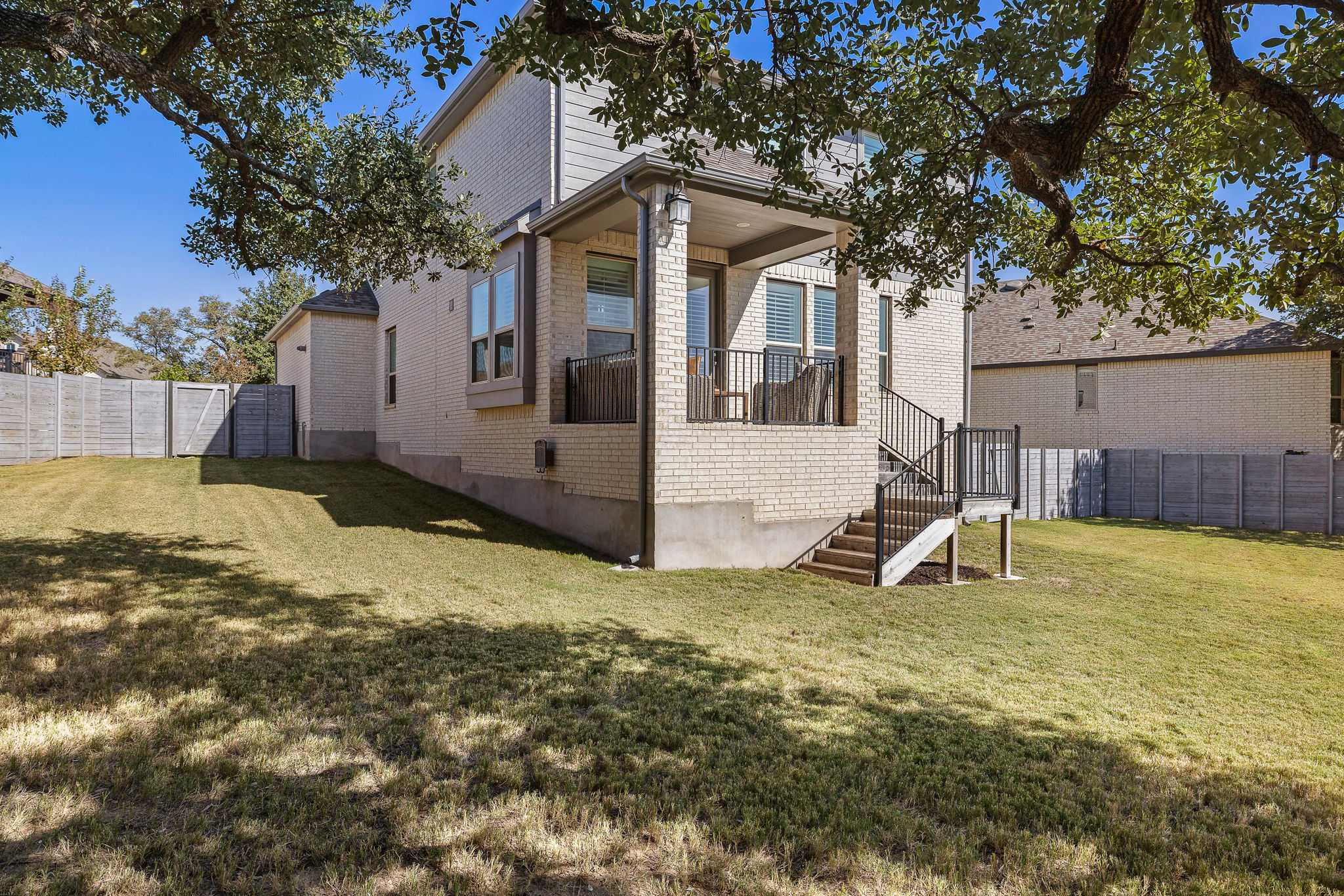604 Pecan Bottom Trail Georgetown, TX 78628 - Photo 32 of 40 Rear view of property with a fenced backyard, brick siding, and stairs