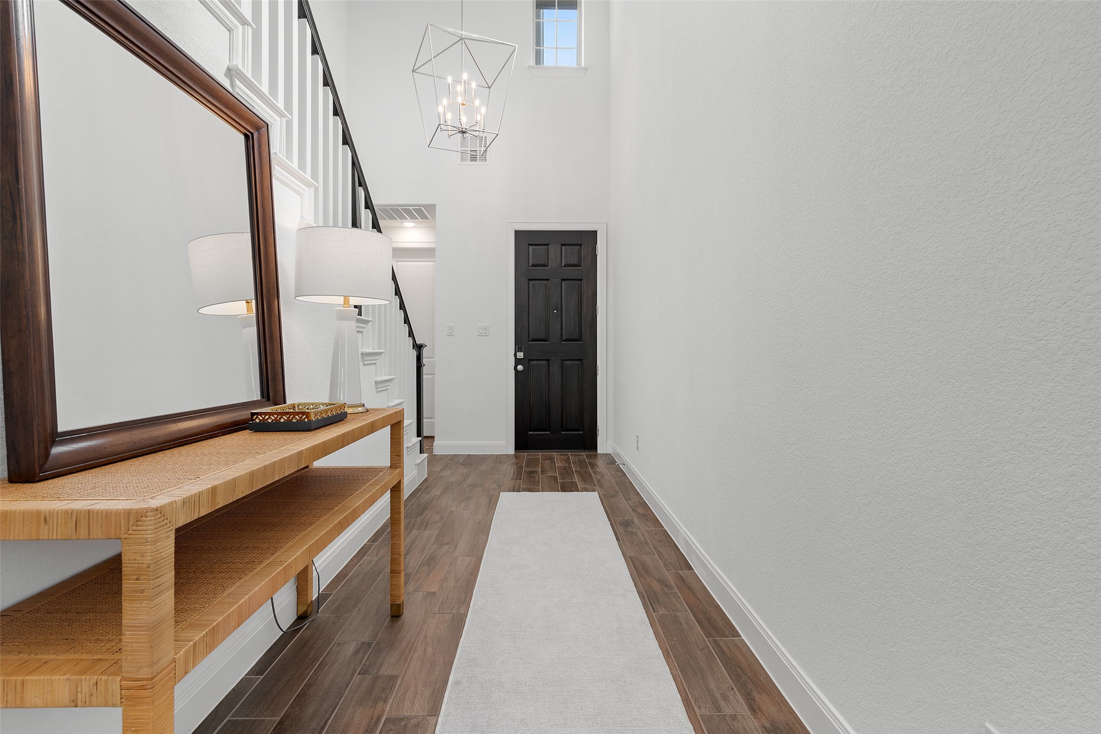 604 Pecan Bottom Trail Georgetown, TX 78628 - Photo 4 of 40 Foyer entrance with wood finish floors, a high ceiling, a chandelier, and stairway