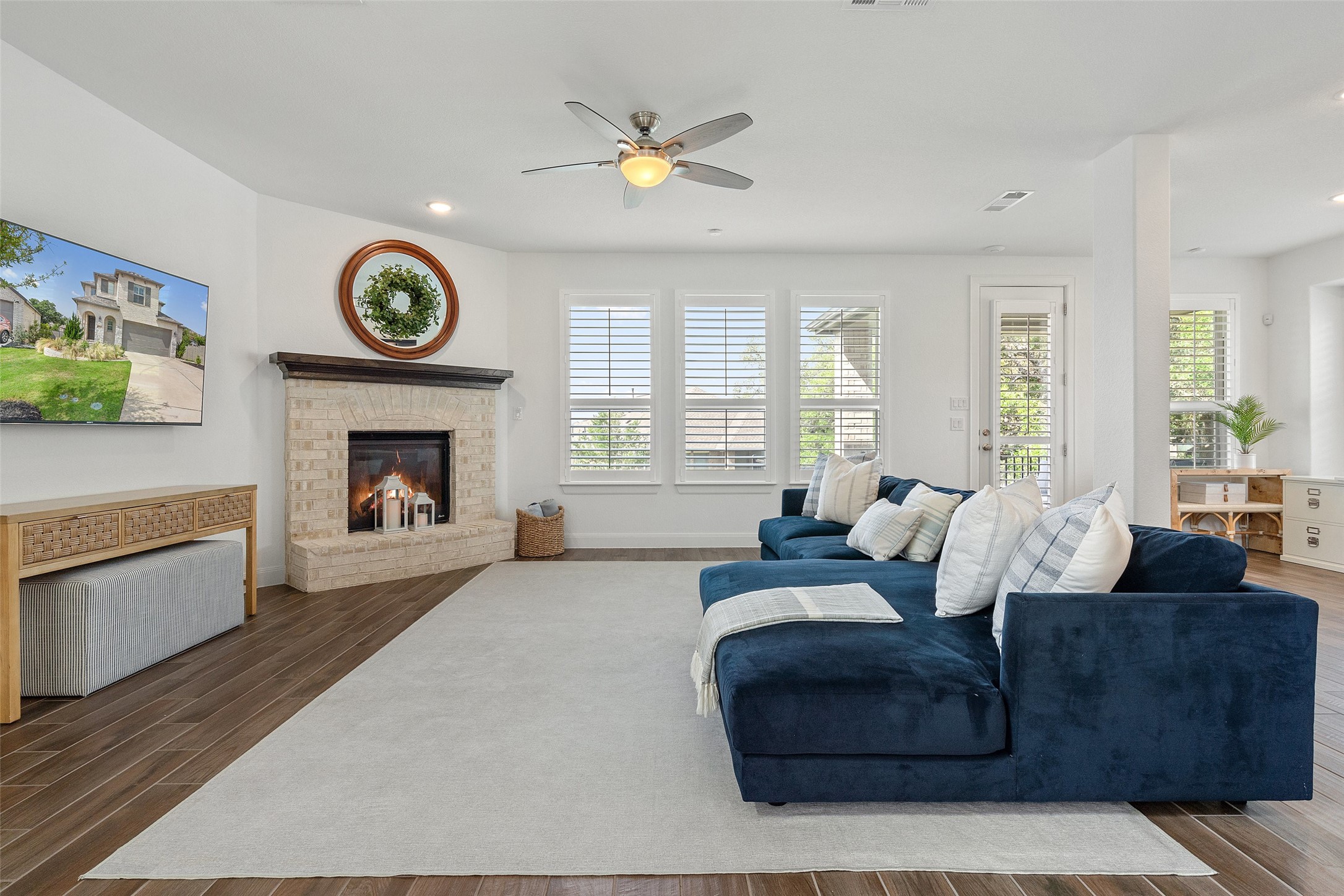 604 Pecan Bottom Trail Georgetown, TX 78628 - Photo 9 of 40 Living area featuring wood finished floors, a fireplace, ceiling fan, and recessed lighting