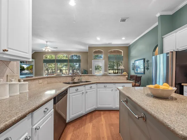 a view of a backyard with table and chairs and potted plants with wooden fence