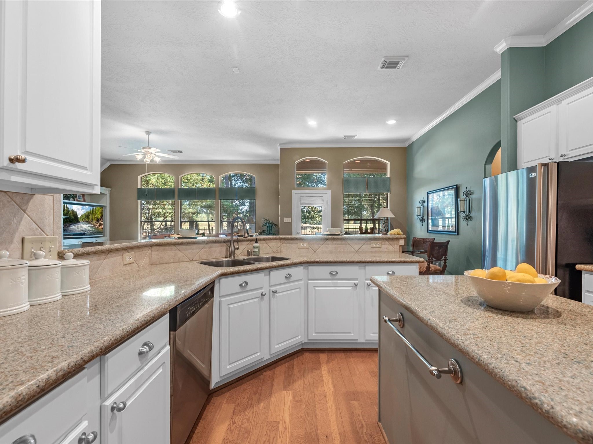 20471 Bentwood Oaks Drive Porter, TX 77365 - Photo 18 of 43 a kitchen with stainless steel appliances granite countertop a sink and a stove