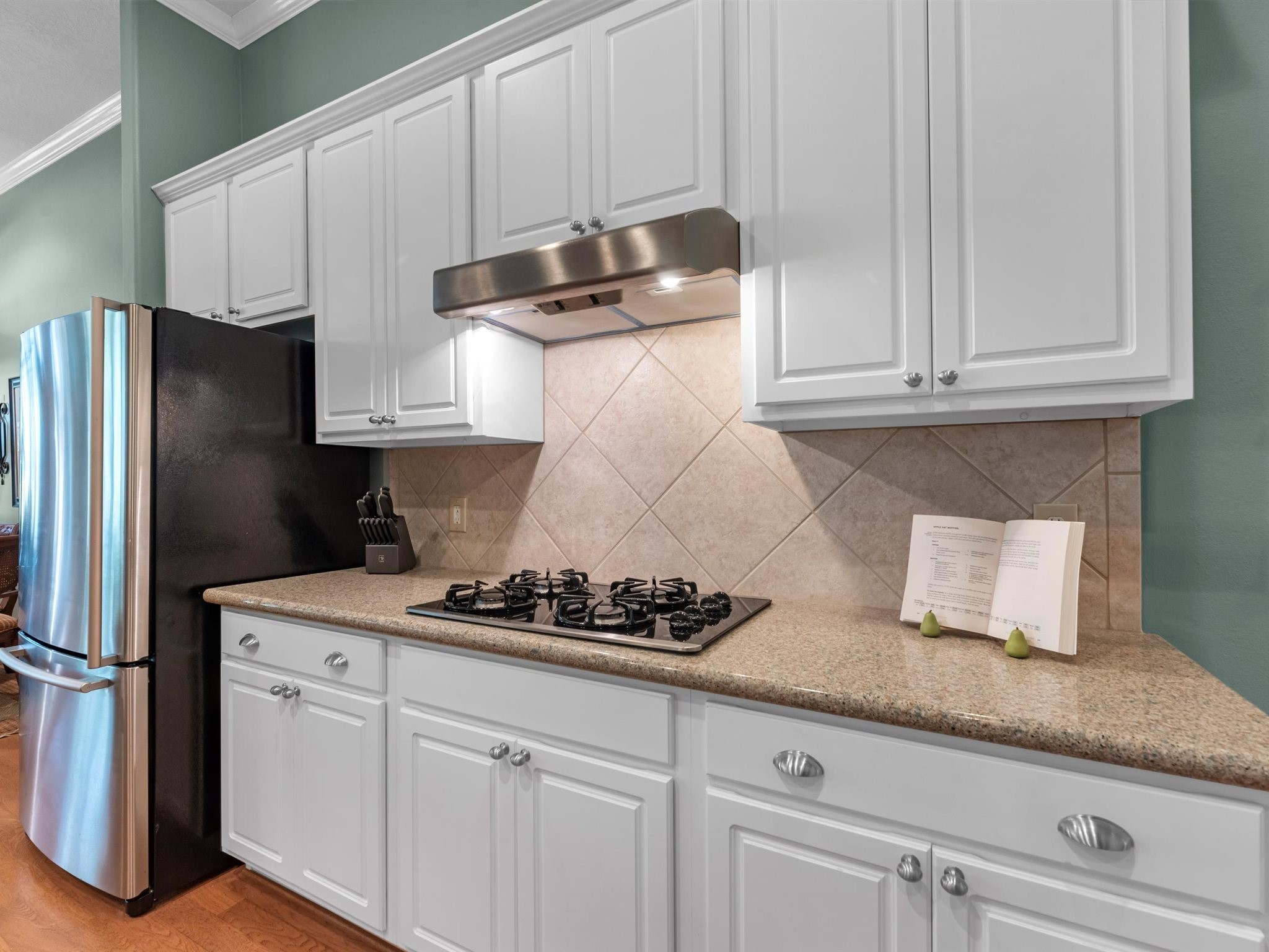 20471 Bentwood Oaks Drive Porter, TX 77365 - Photo 19 of 43 a kitchen with stainless steel appliances granite countertop a sink a stove and a refrigerator