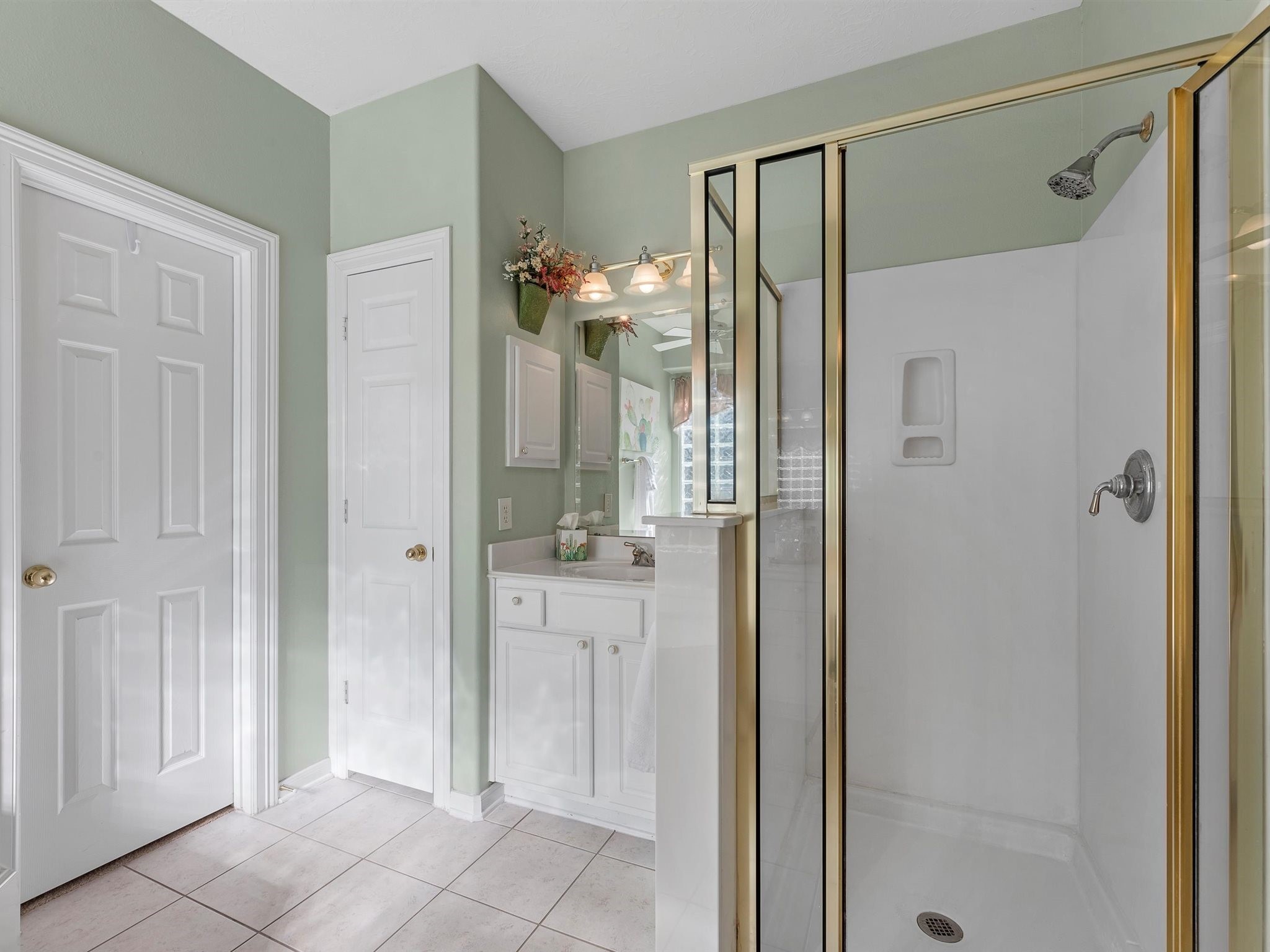 20471 Bentwood Oaks Drive Porter, TX 77365 - Photo 28 of 43 a bathroom with a glass shower door and a mirror