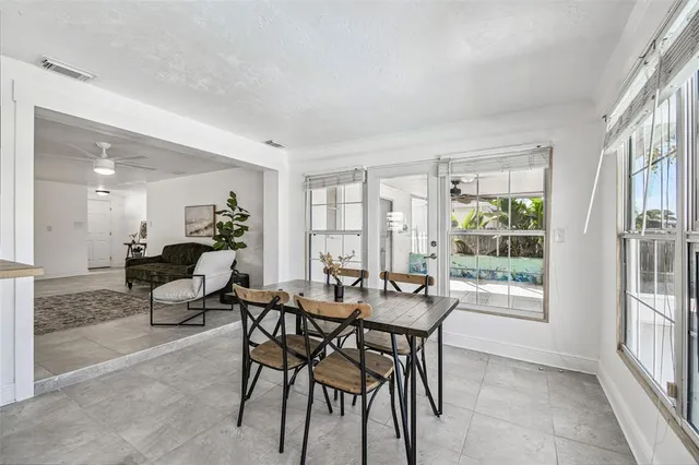 a bathroom with a sink a mirror a toilet and a window