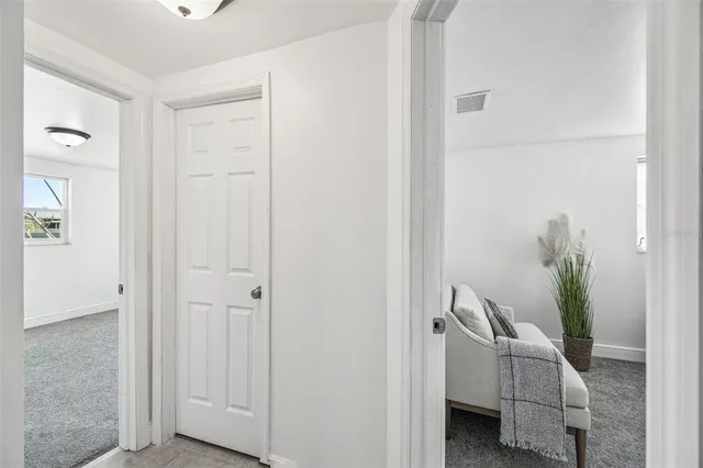 an aerial view of a city with lots of residential buildings ocean and mountain view in back