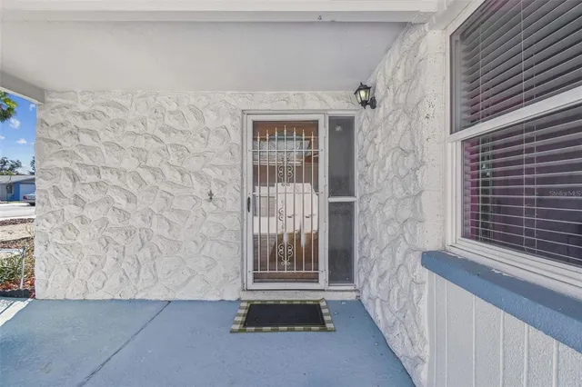 a dining room with furniture and large windows
