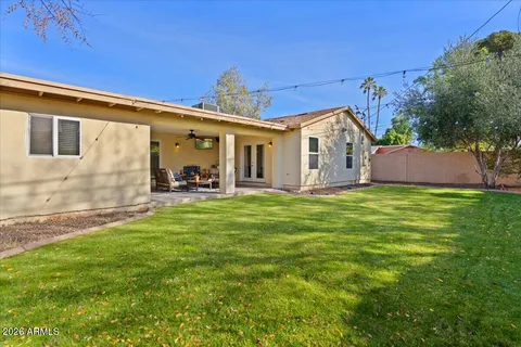 a view of a house with a yard and sitting area