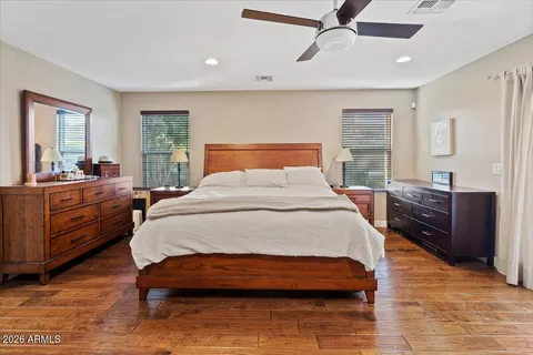 a bedroom with a bed and wooden floor