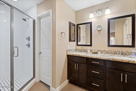 a bathroom with a double vanity sink mirror and double