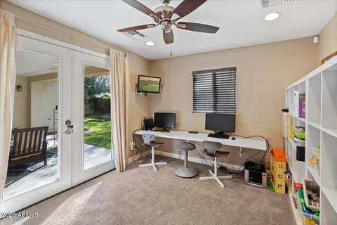 a view of a workspace with furniture and a window