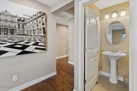 a view of a hallway with wooden floor and entryway