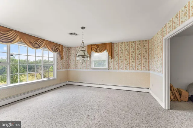 a very nice looking room with wooden floor and a ceiling fan