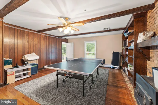 a bedroom with furniture and a wooden floor