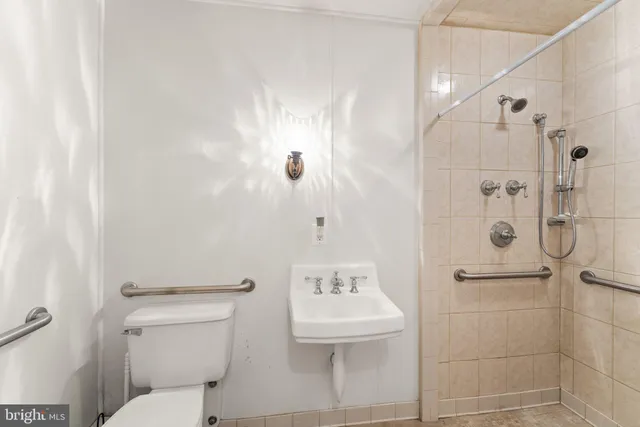 a bathroom with a sink toilet and a mirror