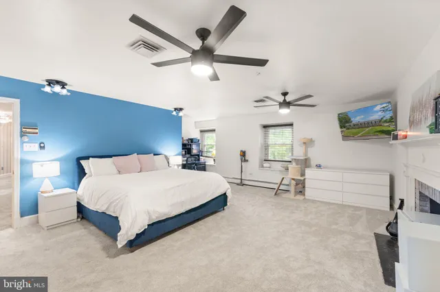 a view of a livingroom with furniture a chandelier and wooden floor
