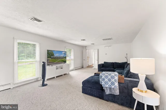 a living room with furniture a table and a chandelier