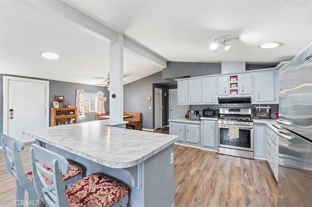 24799 Split Rail Road Wildomar, CA 92595 - Photo 6 of 37 a kitchen with stainless steel appliances granite countertop a stove and a refrigerator
