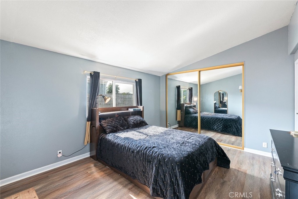 24799 Split Rail Road Wildomar, CA 92595 - Photo 10 of 37 a bedroom with a bed and wooden floor